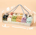 Packaged toy food items with cat-themed packaging on a beige background