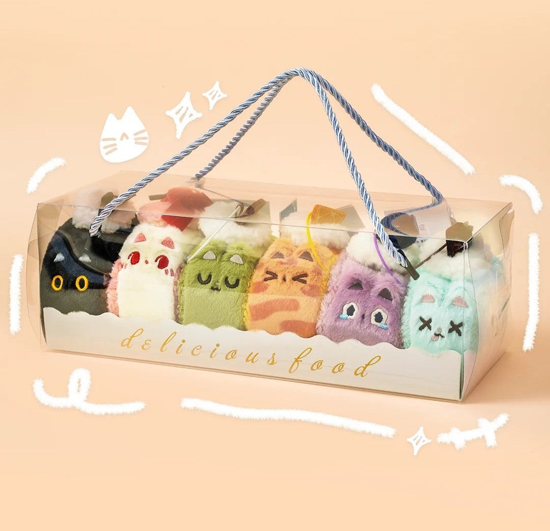 Packaged toy food items with cat-themed packaging on a beige background
