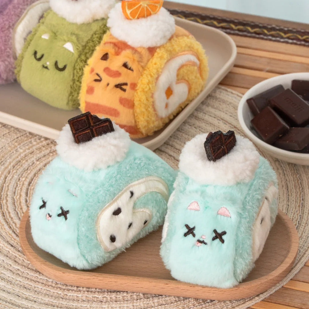 Plush toys shaped like cute desserts on a wooden tray with a light blue background.