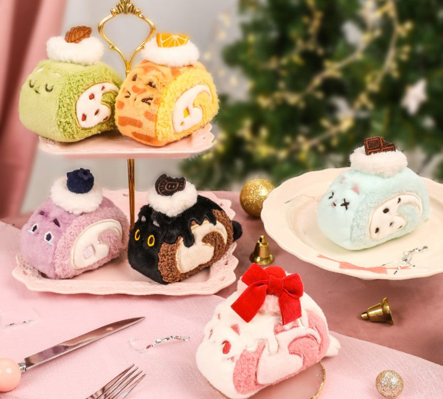 Plush toys shaped like desserts on a pink stand with a blurred Christmas tree in the background.