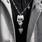 Necklace with a skeleton cat pendant on a black background