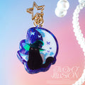 Black cat charm with star and butterfly design on a gradient background