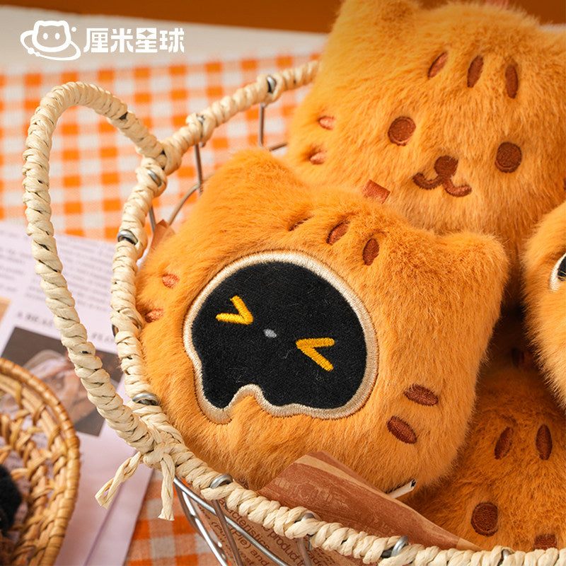 Plush toy resembling a bear with a black face and yellow eyes in a woven basket.
