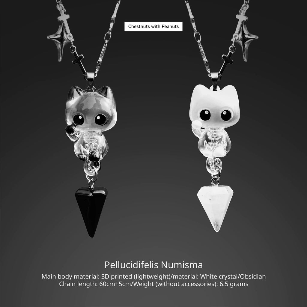 Pair of cat-shaped pendants with 3D printed design on a dark background