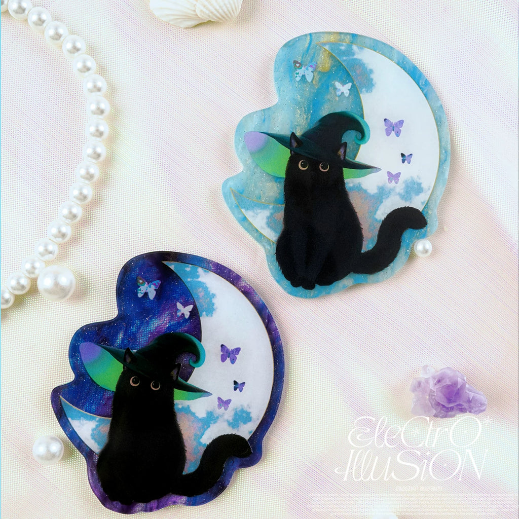 Two black cat magnets on a moon-shaped background with butterflies, branded 'Electro Illusion'.