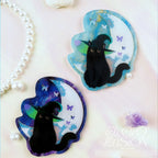 Two black cat magnets on a moon-shaped background with butterflies, branded 'Electro Illusion'.