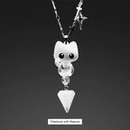 Necklace with a cat-shaped pendant and crystal triangle on a dark background