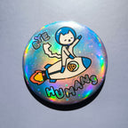 Holographic button with a cat on a rocket and 'BYE HUMANS' text against a gray background