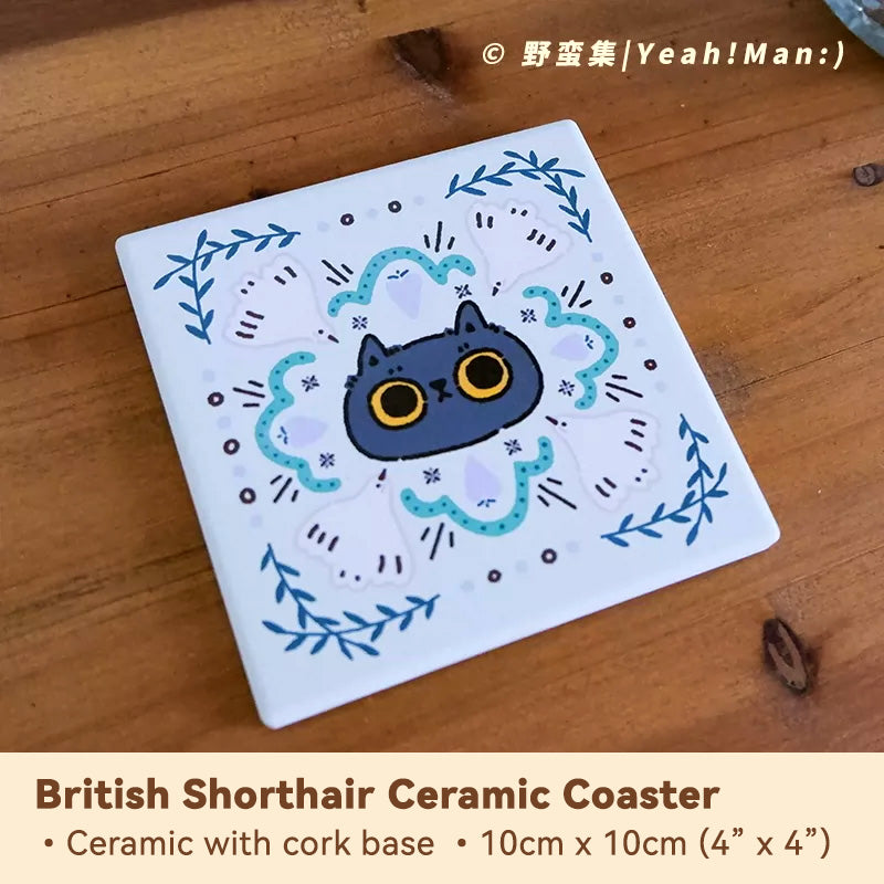 Ceramic coaster with a blue cat design on a wooden surface