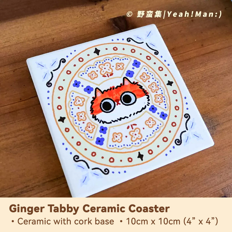 Ceramic coaster with ginger tabby cat design on a wooden surface
