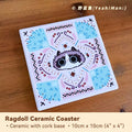 Ceramic coaster with cat design on a wooden surface