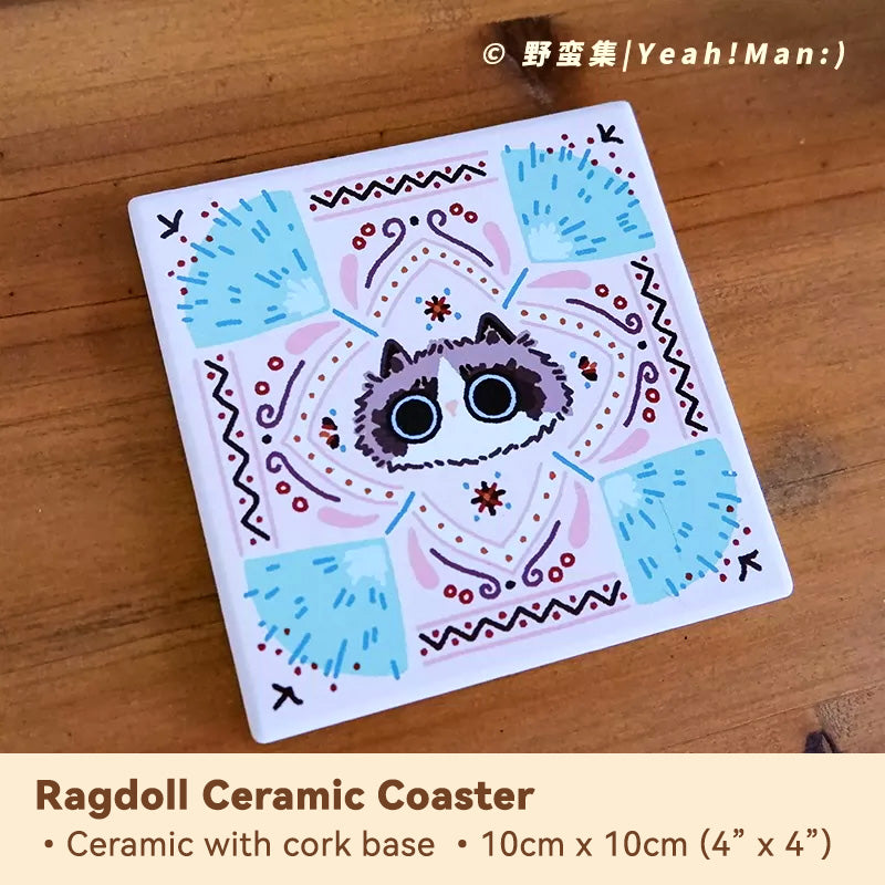 Ceramic coaster with cat design on a wooden surface