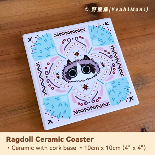 Ceramic coaster with cat design on a wooden surface