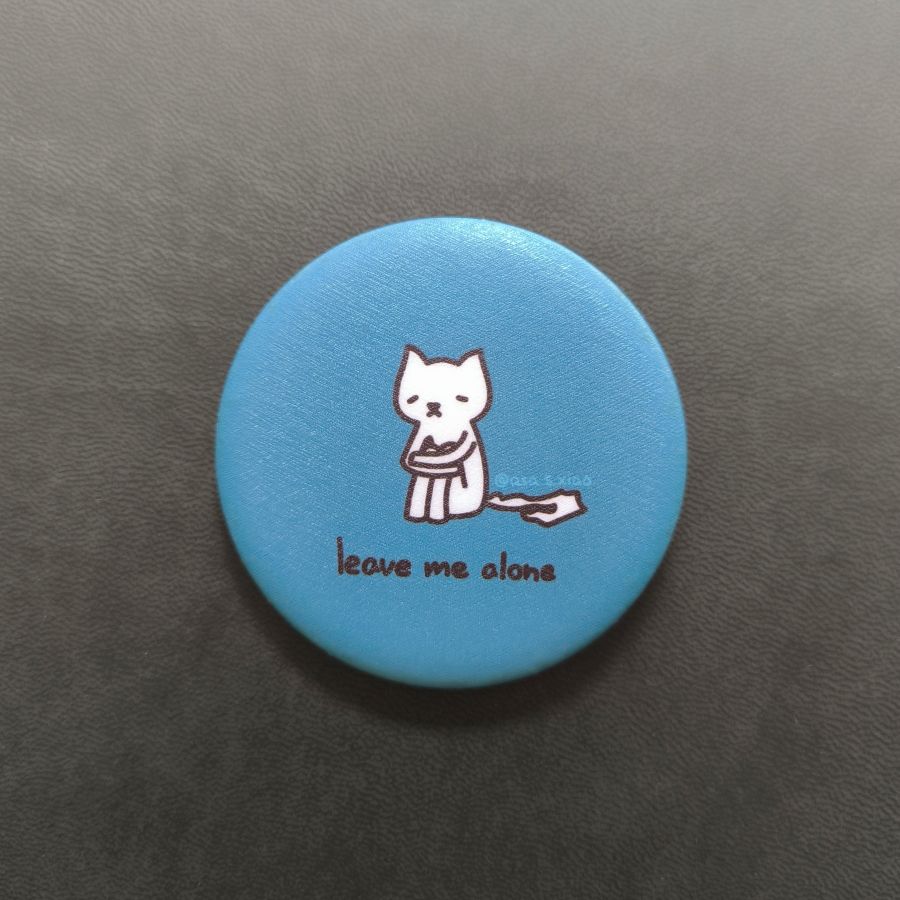 Blue button with a cat illustration and 'leave me alone' text on a dark gray background