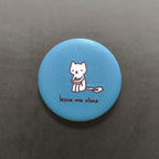 Blue button with a cat illustration and 'leave me alone' text on a dark gray background