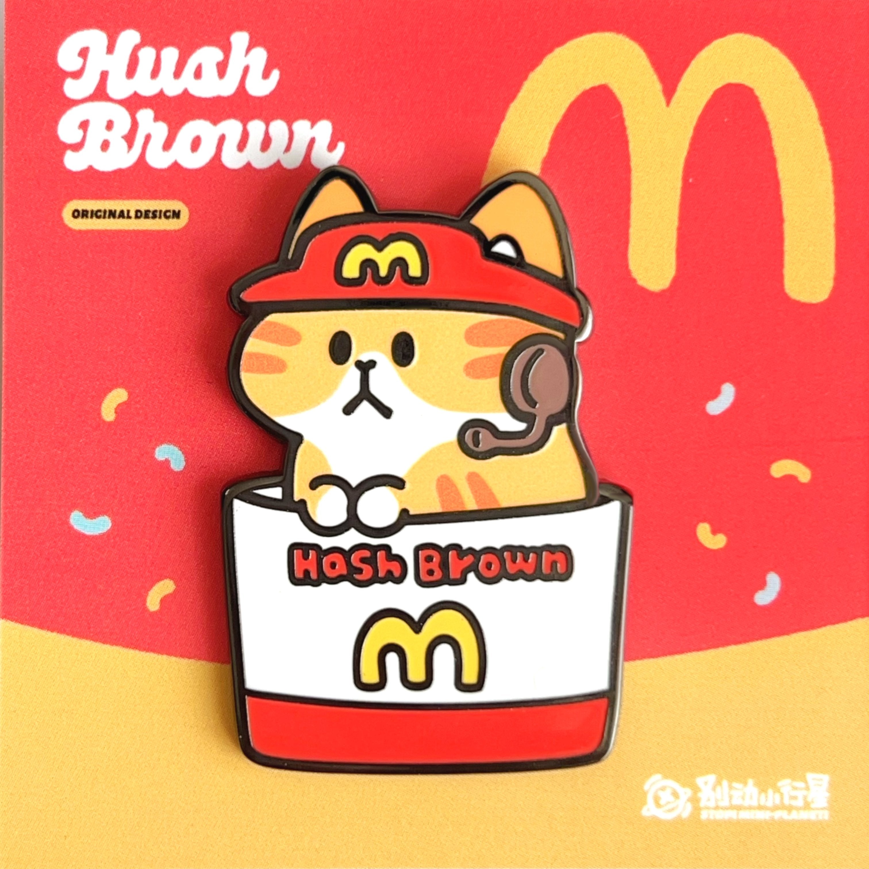 Enamel pin of Hash Brown themed pin with a cartoon cat on a red and yellow background