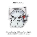 3D epoxy phone griptok with a cat design on a white background