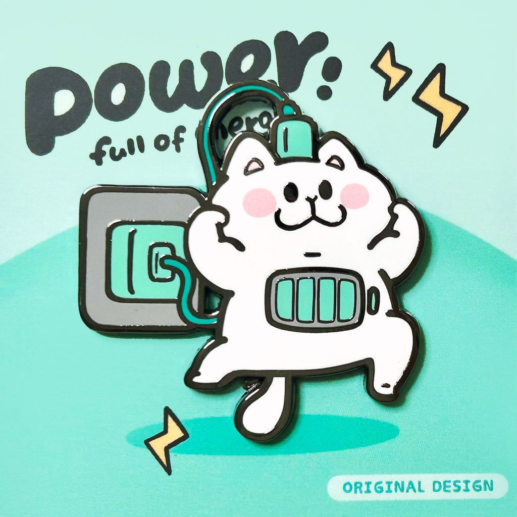 enamel pin of Cartoon cat with power symbol on a light blue background