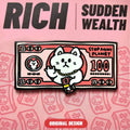 Enamel pin of a cat holding money with 'Rich Sudden Wealth' text on a pink background