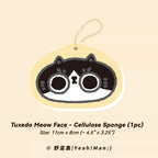 Tuxedo Meow Face cellulose sponge with a beige border on a beige background