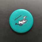 Teal button with a cartoon cat and text 'whatever' on a black background